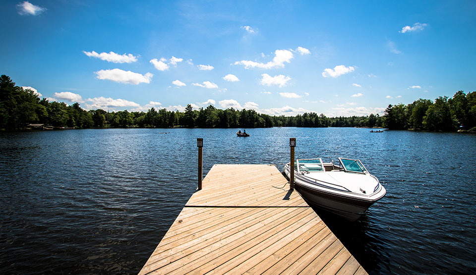 A dock at the cottage on a blue lake